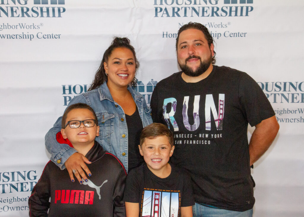 A smiling family during the Housing Partnership funraiser